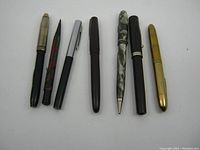 Seven assorted old fountain pens, pencils and pens, side view showing full length and appearances.