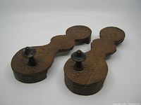 Pair of vintage carved wooden paduka sandals, top view showing pattern and toe knob on each sandal.