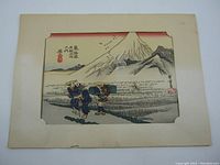 Full view of print within cream paper frame showing composition and overall condition