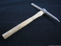 Photo showing the full length of the vintage Murex chipping hammer with metal head and wooden handle, head loose on the handle seen from an angle.