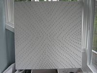 Full view of square white textured artwork showing radiating dot pattern