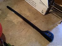 Full view of black padded carrying case for the rod and reel, branded Red Fly Redington.