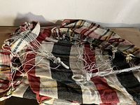 Photo showing the woven striped fabric of the hammock with attached braided ropes.
