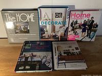 Front view of five home design and decor books arranged standing side-by-side showing titles and cover designs focused on interior design themes.