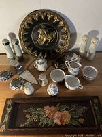 Lot showing all items including decorative tray, ceramic salt and pepper shakers, porcelain dishes, and wooden plaque