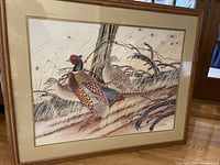 Framed lithograph of ringnecked pheasants in natural autumn setting with trees and grasses.