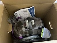 Bissell SpotClean Pet Pro unit with hose and brush tool in cardboard box