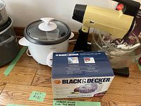 Wide view showing Rival rice cooker, Black & Decker food processor box, vintage electric mixer with glass mixing bowl