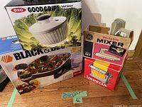Photo shows Oxo Good Grips salad spinner box, Black & Decker electric skillet box, GE portable mixer box, and Imperia pasta maker attached to the mixer.