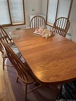 Overview of oak kitchen table with two leaves inserted and four chairs