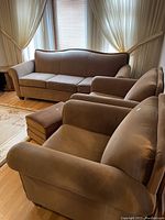 Three-piece seating set including sofa and two chairs placed in living room