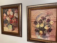 Two floral framed paintings side by side on a wall