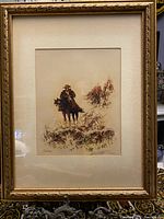 Framed artwork showing "Cowboy on a Horse" signed by A. Amir, with gold ornate frame and matting.