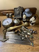 Collection of assorted small collectable items arranged on a wooden surface.