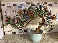 Full view of the vintage bonsai tree with multicolored jade flowers and leaves in ceramic pot.