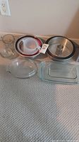 Image showing metal tube cake pan, metal mixing bowls, clear glass mixing bowl, and white measuring cups.