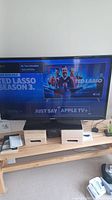 Front view of Samsung 40 inch TV powered on displaying Apple TV interface with Ted Lasso Season 3 promotional image.