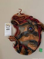Abstract swirling design mask with blue eye, signed, approx. 12x13 inches