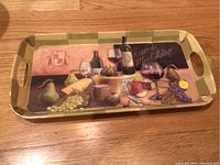 Top-down view of the rectangular plastic serving tray with printed wine, cheese, and fruit design.