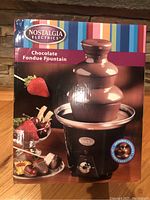Box of Nostalgia Electrics Chocolate Fondue Fountain with product image and size specifications.
