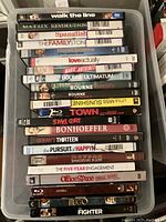 Top view photo showing DVD and Blu-ray movie titles stacked, including titles such as Walk the Line, The Matrix Revolutions, and Love Actually.