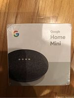 Front view of sealed Google Home Mini box showing brand name and image.