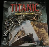 Box cover of 'Murder on the Titanic' 1000-piece puzzle with thematic imagery including a gun, jewelry, and photographs.