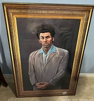 Front view of framed Kramer poster showing character wearing beige suit with blue shirt.