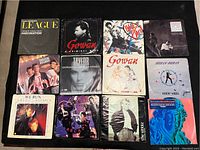 Photo of 12 vinyl record sleeves showing various 1980s artists including The Human League, Gowan, A-ha, T'Pau, Arcadia, and New Order.