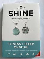 Retail box of Misfit Shine fitness and sleep monitor pendant showing front cover with product images and descriptions.