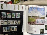 Photo showing four horizontal mounted UK stamp sets in album pages with botanical and lighthouse images, and a photo of a glasshouse.
