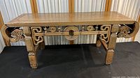 Front view of full bench showing carved apron, legs, and overall proportions