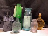 All six bottles and the package of lid clamps shown together against a black background