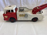 Front and side view of pressed steel tow truck red and white with Hi-Way Emergency decal on side, showing condition and missing parts.