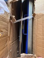 View down into the box showing blue frame and parts of cart components.