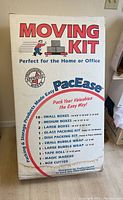 Box front showing 'Moving Kit' branding and contents list describing the items in the kit.