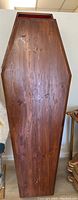 View of the coffin's top lid showing wood grain and shape