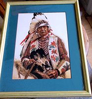 Framed art print showing full portrait of Native American chieftain with feathered headdress and traditional decorative dress.
