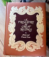 Front cover of the cookbook showing the title and authors in gold decorative design on brown background.