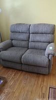 Front view of loveseat in upright position showing overall upholstery pattern and condition.