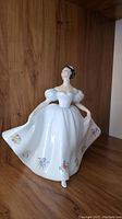 Front view of Royal Doulton Kate figurine with fully visible white dress and floral decoration