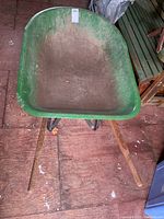 Top view of the green metal bucket showing dirt and wear.