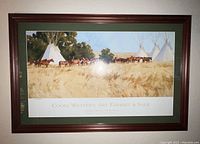 Framed poster showing western scene with horses and tipis, titled with event and artist details.