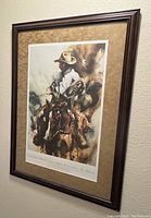 Full framed and matted poster hanging on wall showing the artwork and frame style.