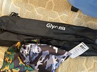 Two black carrying pouches with Glymnis logo, plus camo fabric pouch included in the lot.