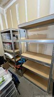 Two matching shelving units side by side, empty.