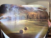 Poster titled "Steamboat Pastures" by Gordon Brown showing rural landscape with hay bales and dramatic sky