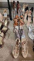 Five pairs of women's heels in size 10, various styles and colors.