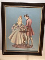 Full view of lithograph print in dark painted wood frame with beige matting and glass cover, depicting a man and woman near a flower-adorned table.