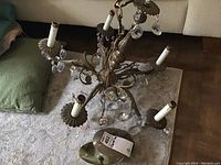 Top view showing the general shape and crystal details of the brass chandelier and candle lights.